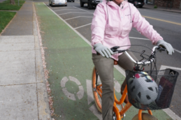 gal riding on Franklin Avenue's parking protected bike lane