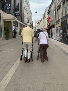 photo of older people walking on a walking street