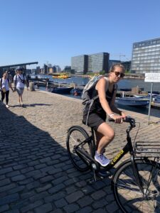 photo of people walking and biking along inner harbor in Copenhagen
