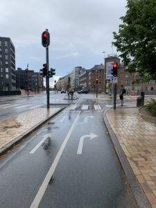 Photo Odense Denmark, shows lane markings for thru and right turns in bike lane